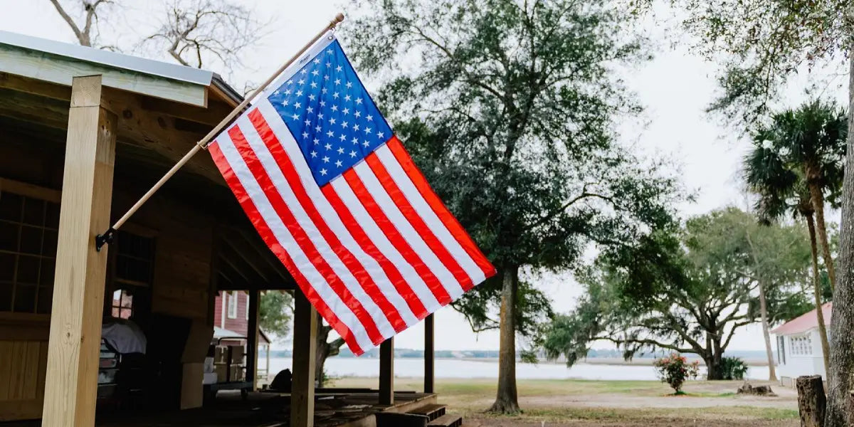 A half-staff flag display is not shown, but this American flag mounted on a wooden post follows respectful flag practices.